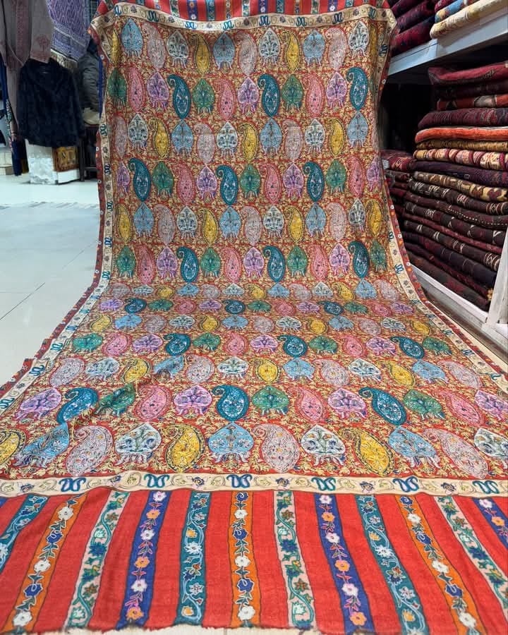Traditional Kani Pashmina shawl featuring intricate handwoven paisley motifs in vibrant colors of turquoise, gold, and coral with ornate floral patterns and decorative striped border